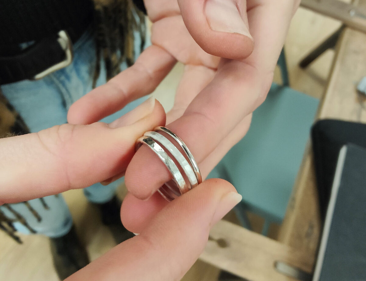 a set of three rings is being made and sit on a finger