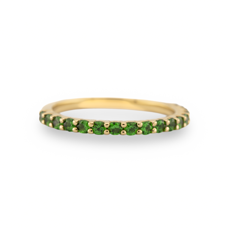 A green tsavorite garnet and 18ct gold half eternity ring.